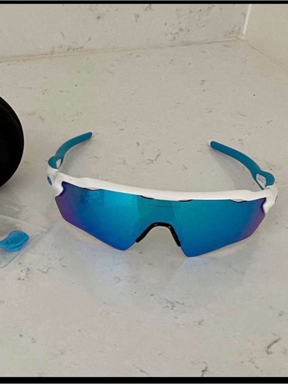 Oakley White Frame Sunglasses with Blue Lenses and Blue Temple Tips